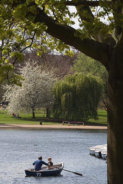 April Hot Weather: A man and boy row a boat in the Serpentine