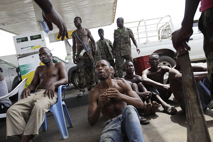 Ivory Coast: 6 April: A captured man pleads his innocence at a checkpoint