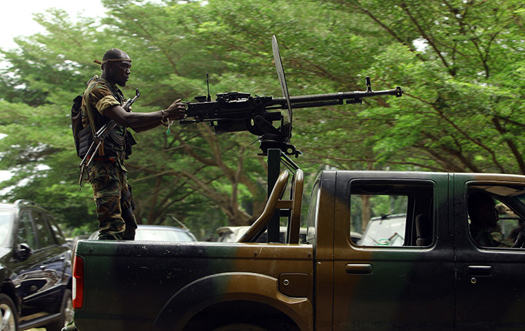 Ivory Coast: 6 April: A soldier fighting for Alassane Ouattara points a weapon