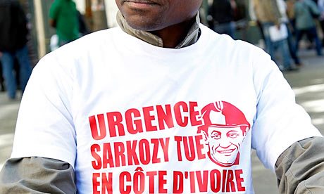 A pro-Gbagbo protester wears a shirt declaring 'Emergency Sarkozy kills in Ivory Coast'