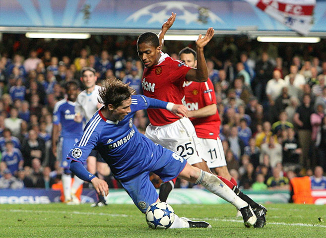 Chelsea v United: Fernando Torres goes down in the area after a challenge by Valencia