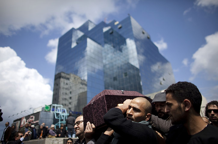 24 hours in pictures: Friends and relatives carry the coffin of Juliano Mer-Khamis, Israel