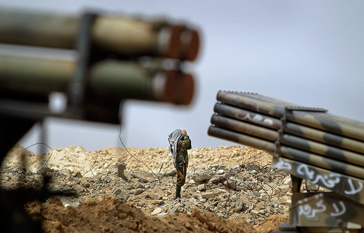 24 hours in pictures: A Libyan rebel fighter between multiple rocket launchers