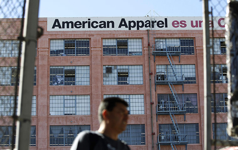 Week in Business: A man walks past the American Apparel headquarters in Los Angeles