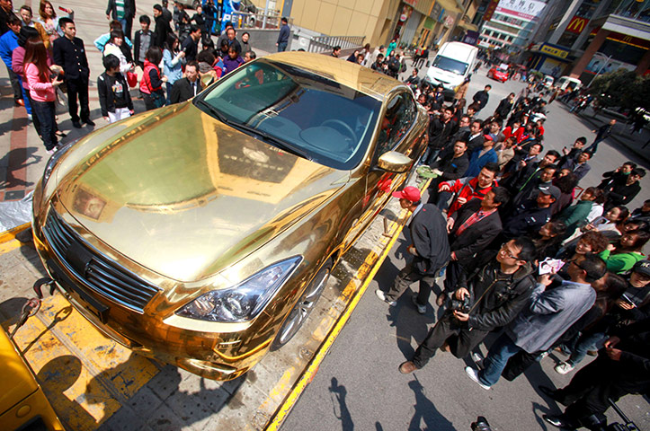 Week in Business: A gold-plated Infiniti luxury sports car outside a jewellery store in China