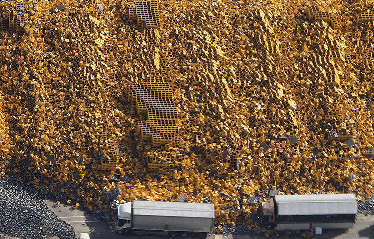 Week in Business: Fallen plastic crates outside a factory compound in Sendai
