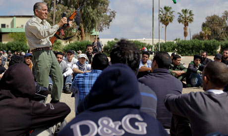 An instructor at the Benghazi rebel training camp shows new recruits how to use and maintain an AK47