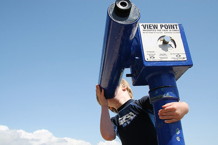 Vantage Point: A boy looking through a telescope in Dorset