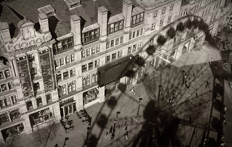 Vantage Point: the big wheel in Manchester casting a shadow over nearby buildings