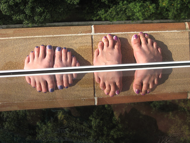 Vantage Point: feet on a balcony reflected in the glass