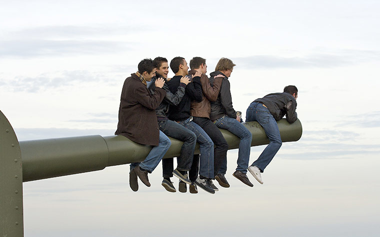 Vantage Point: Men sitting on the barrell of a cannon at Monjuic castle