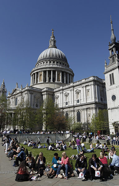 April Hot Weather: City workers relax in the sun near St Paul's Cathedral in London