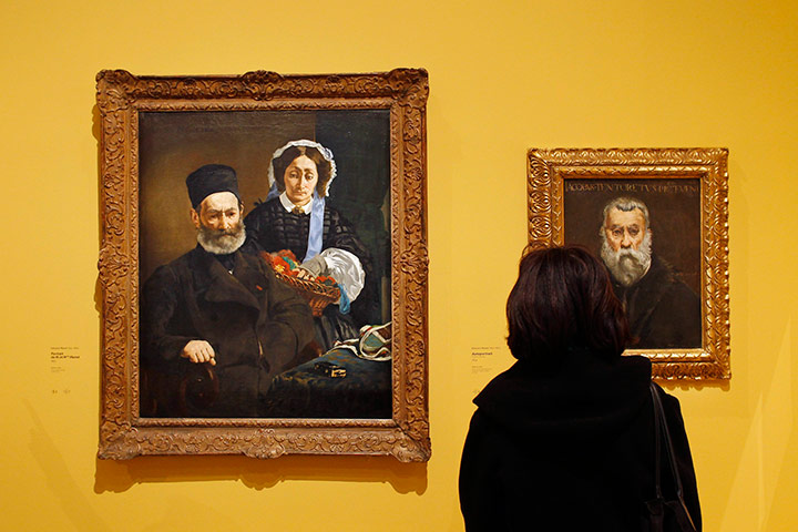 Manet at Musee d'Orsay: A visitor looks at paintings by French painter Edouard Manet