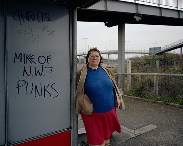 Whitechapel Gallery: Woman at Bus Stop, Mill Hill, North London, November 1982 by Paul Graham