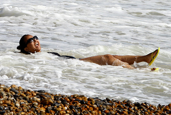 April Hot Weather: A woman enjoys the sunshine in Brighton
