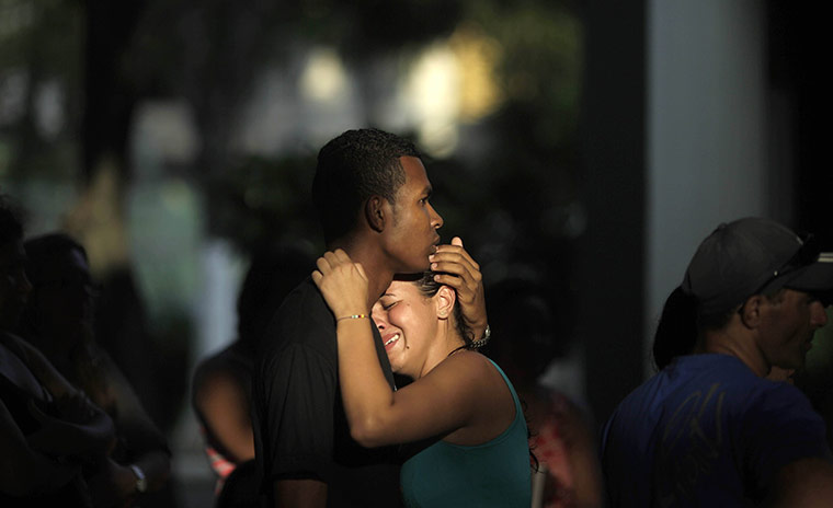 24 Hours in Pictures: Friends of shooting victim Igor Moraes da Silva attend the funeral in Rio