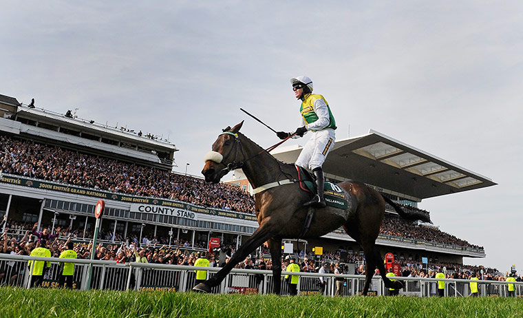 Grand National: Jason Maguire celebrates victory as Ballabriggs crosses the finish line