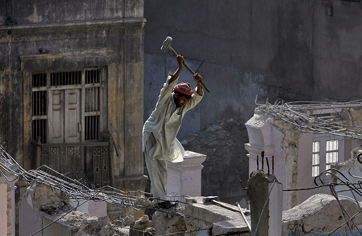 24 hours: Karachi, Pakistan: A labourer works on a construction site 