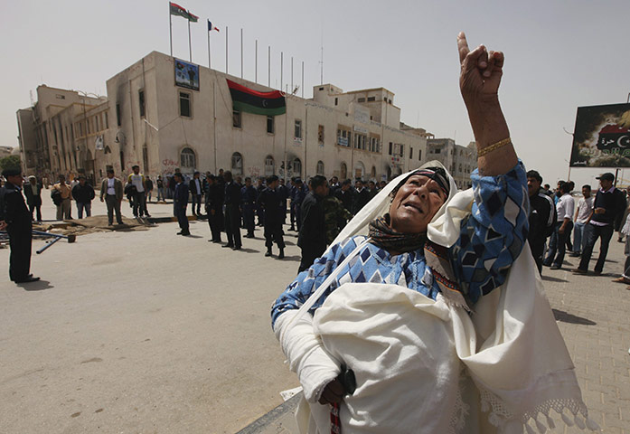 24 hours: Benghazi, Libya: A Libyan woman gestures in support of rebel fighters