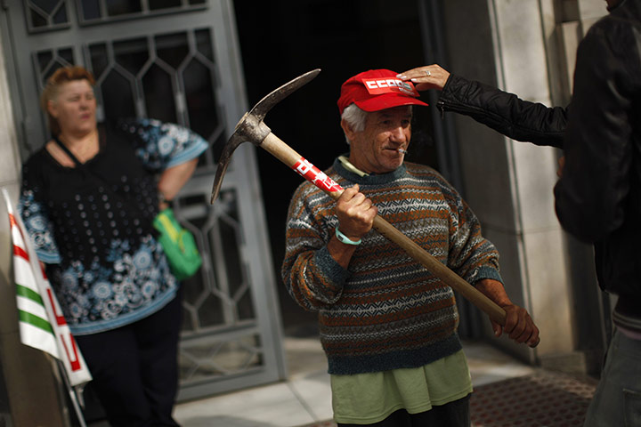 24 hours: Malaga, Spain: A woman places a CCOO trade union sticker