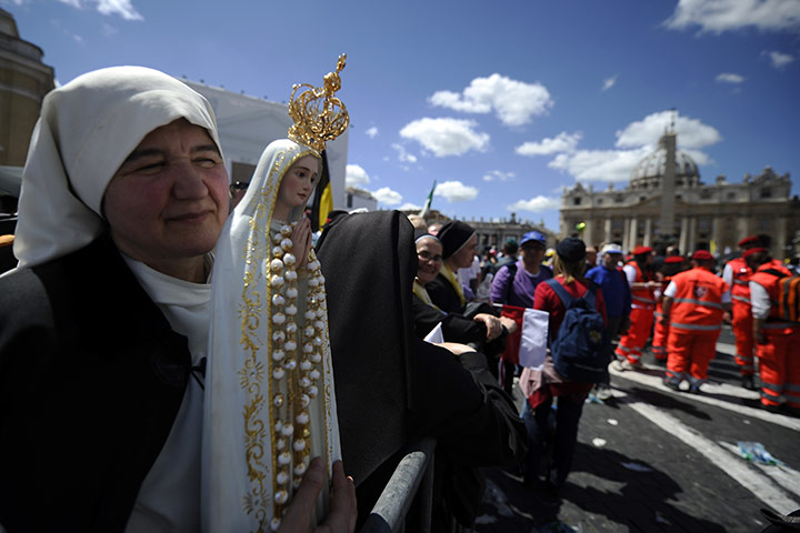 Beatification: A nun holds a statue of Virgin Mary in front of  St Peter's basilica