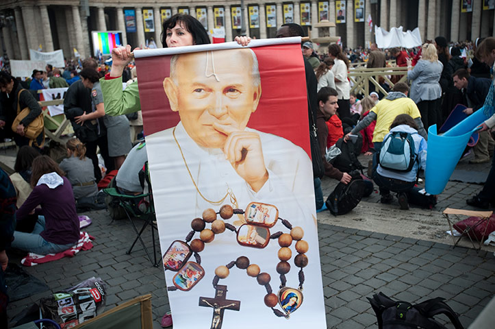 Beatification: A pilgrim holds a banner of the image of John Paul II 