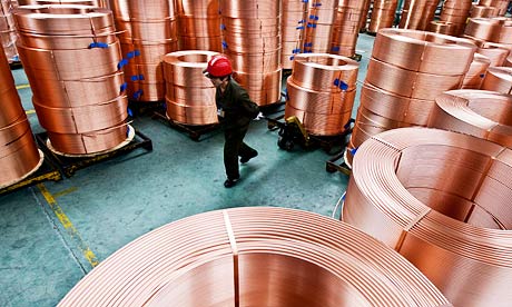 Factory worker moves brass tubes