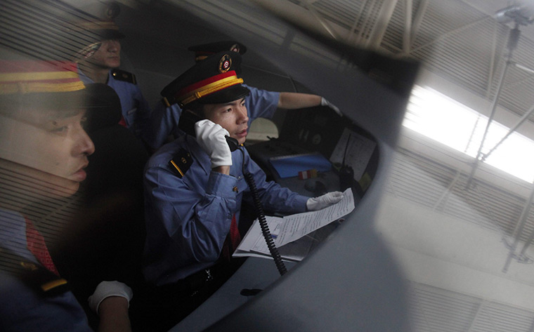 24 hours : Shanghai, China: A driver makes a phone call in the cabin of a bullet train
