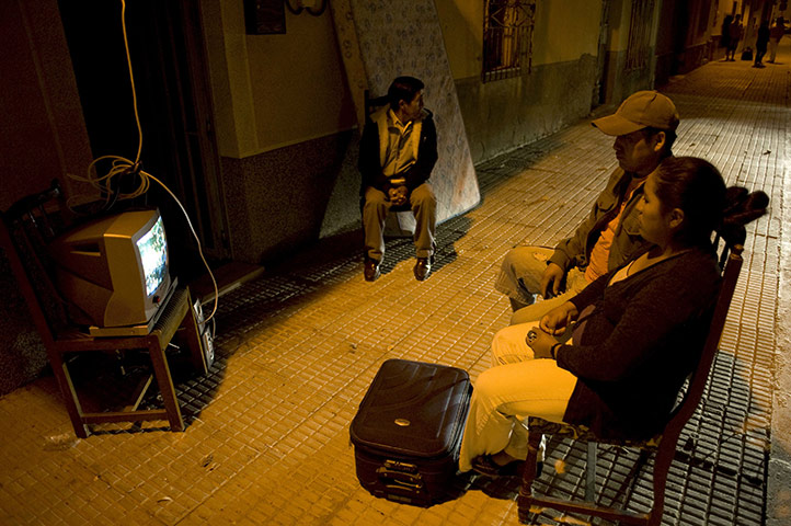 Lorca earthquake: People watch tv on a street  in Lorca