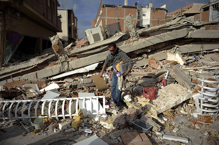 Lorca earthquake: A man collects his belongings from a destroyed house in Lorca