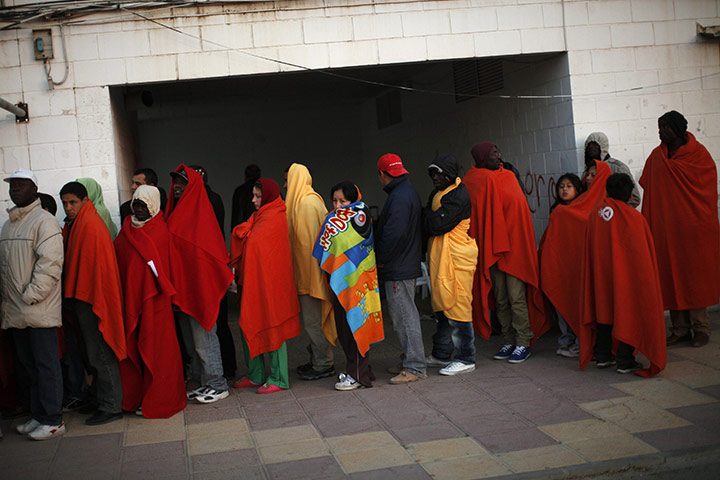 Lorca earthquake: Residents line up during food distribution after spending the night outside
