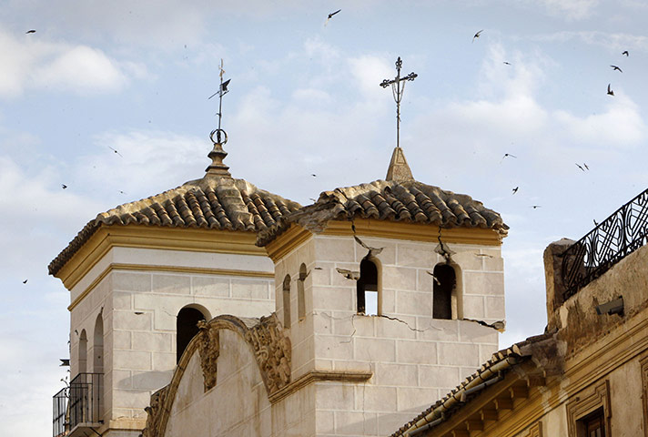 Lorca earthquake: Birds fly over the damaged bell tower of a church in Lorca