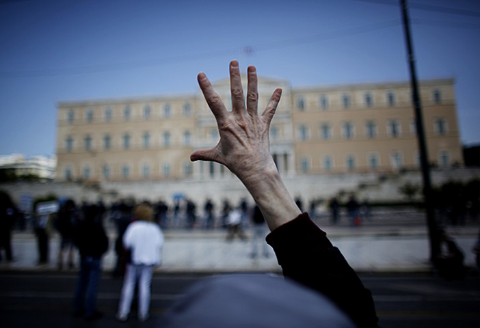 24 hours in pictures:  protester gestures in front of the Greek Parliament