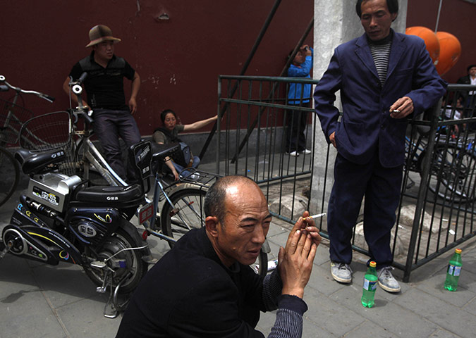 From the Agencies: Men smoke on a street of Beijing