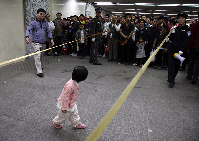 From the Agencies: A girl stands in an underpass leading to Tiananmen Square