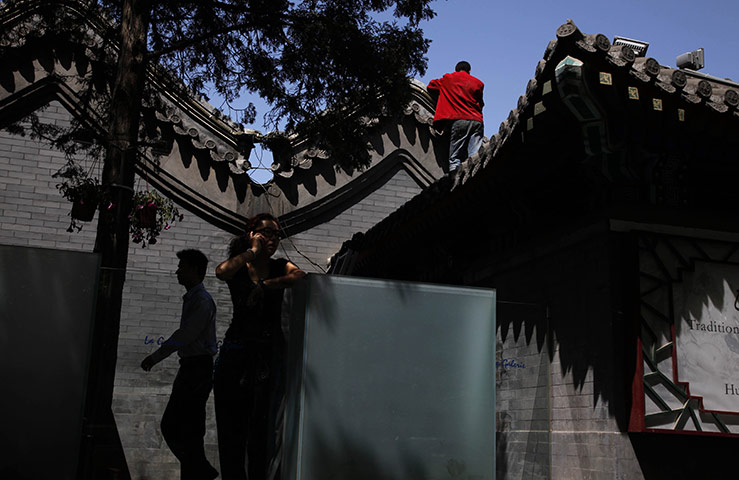 From the Agencies: A woman talks on her cell phone outside a restaurant