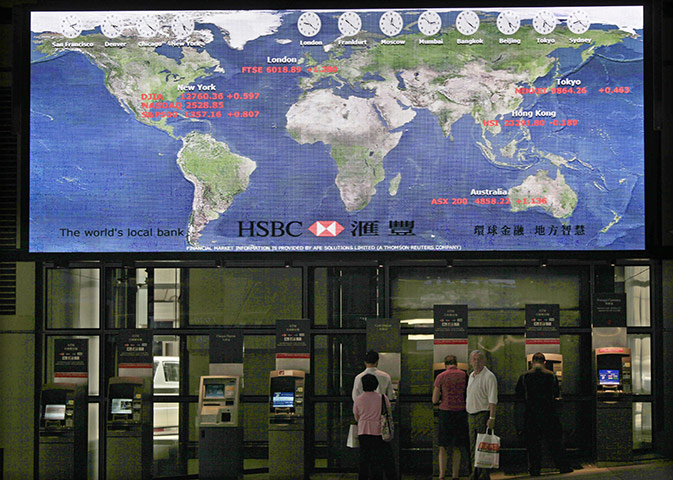 Week in Business: Customers use cash machines at the Hong Kong HQ of HSBC in Hong Kong