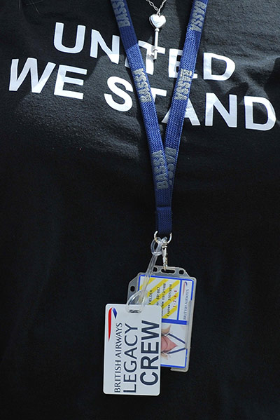 Week in Business: A British Airways crew member leaves following union meetings 