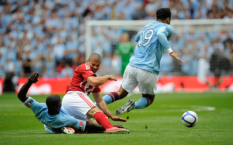 FA Cup Final City v Stoke: Lescott goes flying after being caught by Walters and team-mate Richards