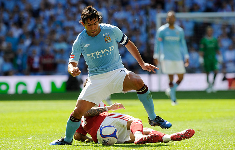 FA Cup Final City v Stoke: Carlos Tevez evades a tackle from Jermaine Pennant