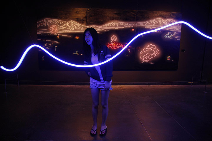 24 hours: Beijing, China: A visitor looks at an art work by Kong Lingnan