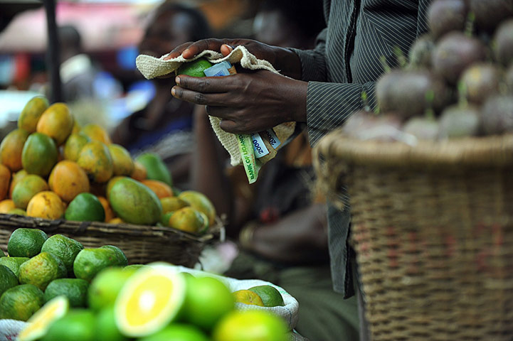 24 hours: Kampala, Uganda: A vendor sells fruit and vegetables at Nakasero market 
