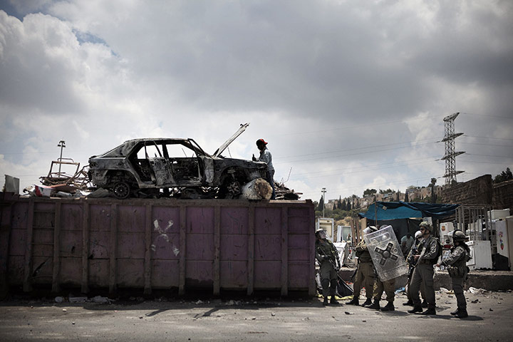 Israel violence: Israeli policemen take position during clashes in the Shufat refugee camp
