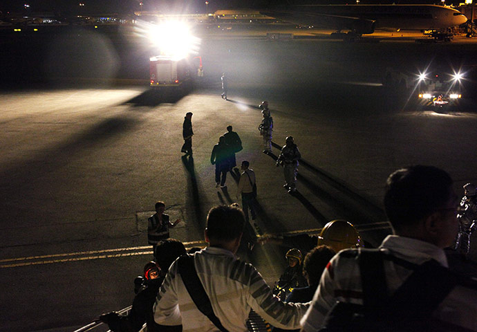 24 hours in pictures: Passengers disembark from Cathay Pacific flight at Singapore Changi Airport