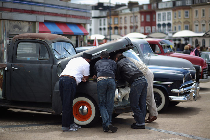 Rockabilly Weekender: Men in period clothing gather by an old truck