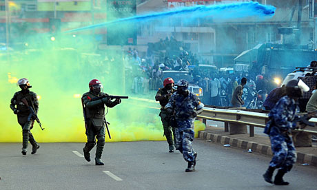 Ugandan anti-riot personnel fire teargas to disperse supporters of opposition leader Kizza Besigye