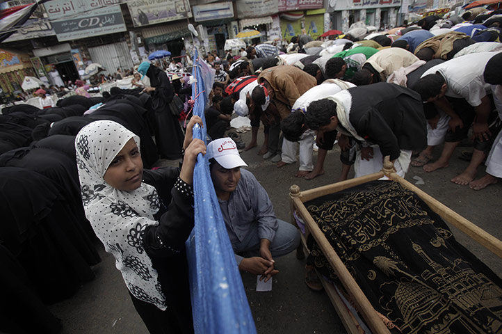 24 hours: Sana'a,Yemen: A girl looks from the side of the female protesters