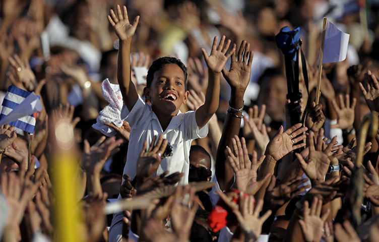 24 hours: Havana, Cuba: A boy joins a group of workers chanting slogans