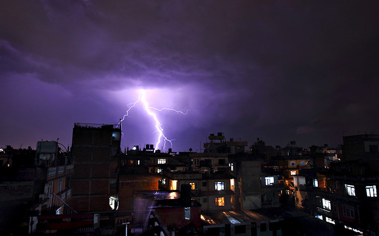24 hours: Kathmandu, Nepal: Lightning strikes over buildings during a thunderstorm