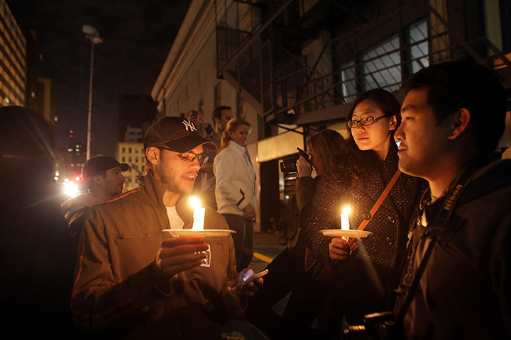 Bin Laden US reaction: People light candles as they celebrate in the streets at Ground Zero